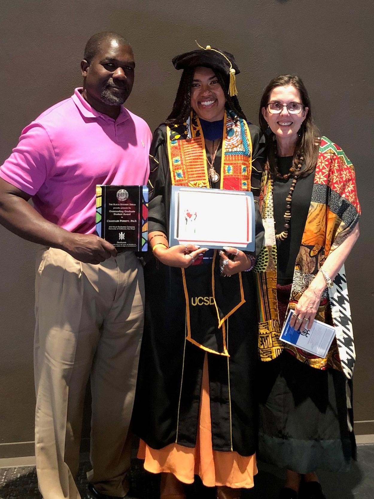 Chandler Puritty standing with her parents after receiving the 2019 Black Student Union's Outstanding Graduate Student Award.