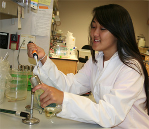 Photo of student pipetting dangerously close to a bunsen burner