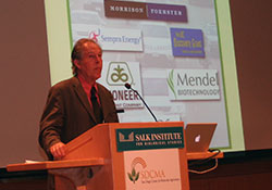 Richard Somerville standing next to a screen giving a talk onstage
