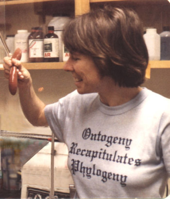 Meredith Gould holding a red object in the lab