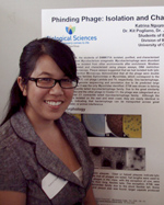 Photo: Student stands in front of poster explaining her research
