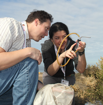 Two students examine a captured insect.