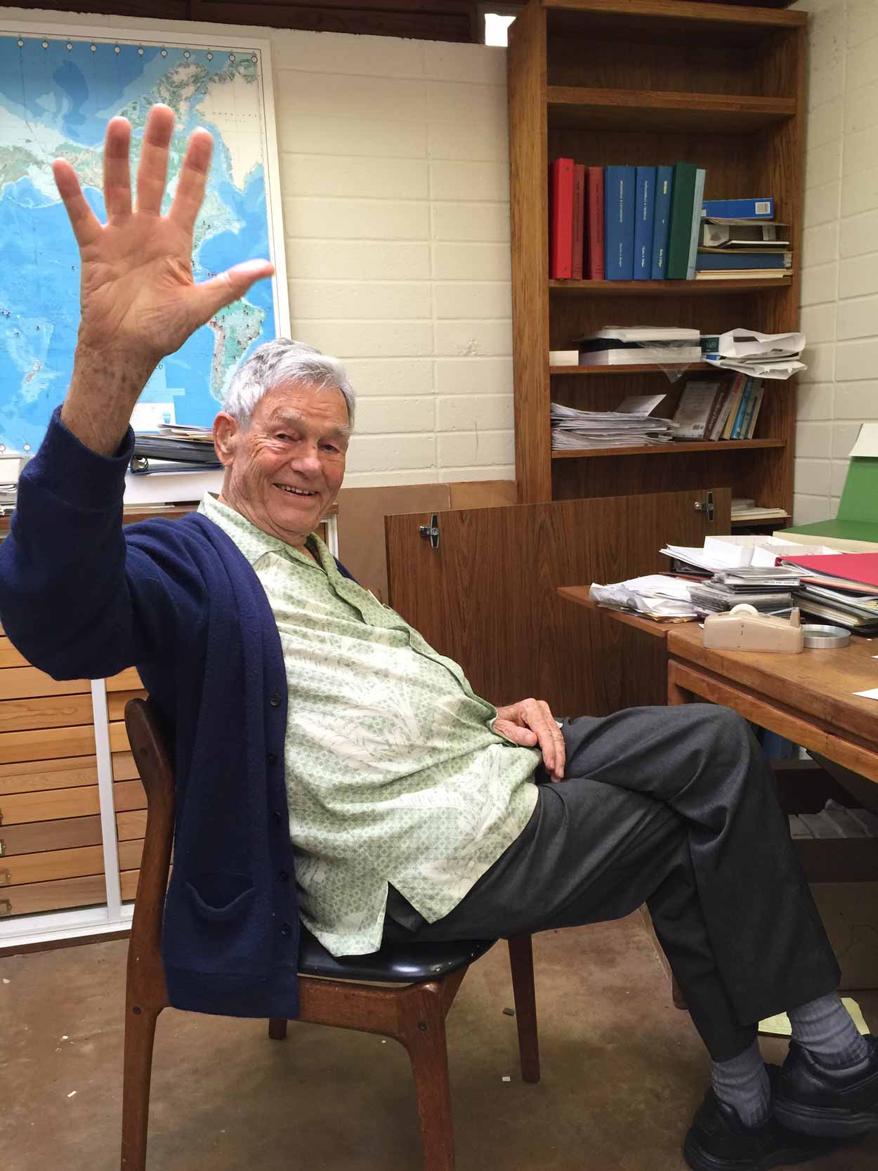 Dan Lindsley waving in his office