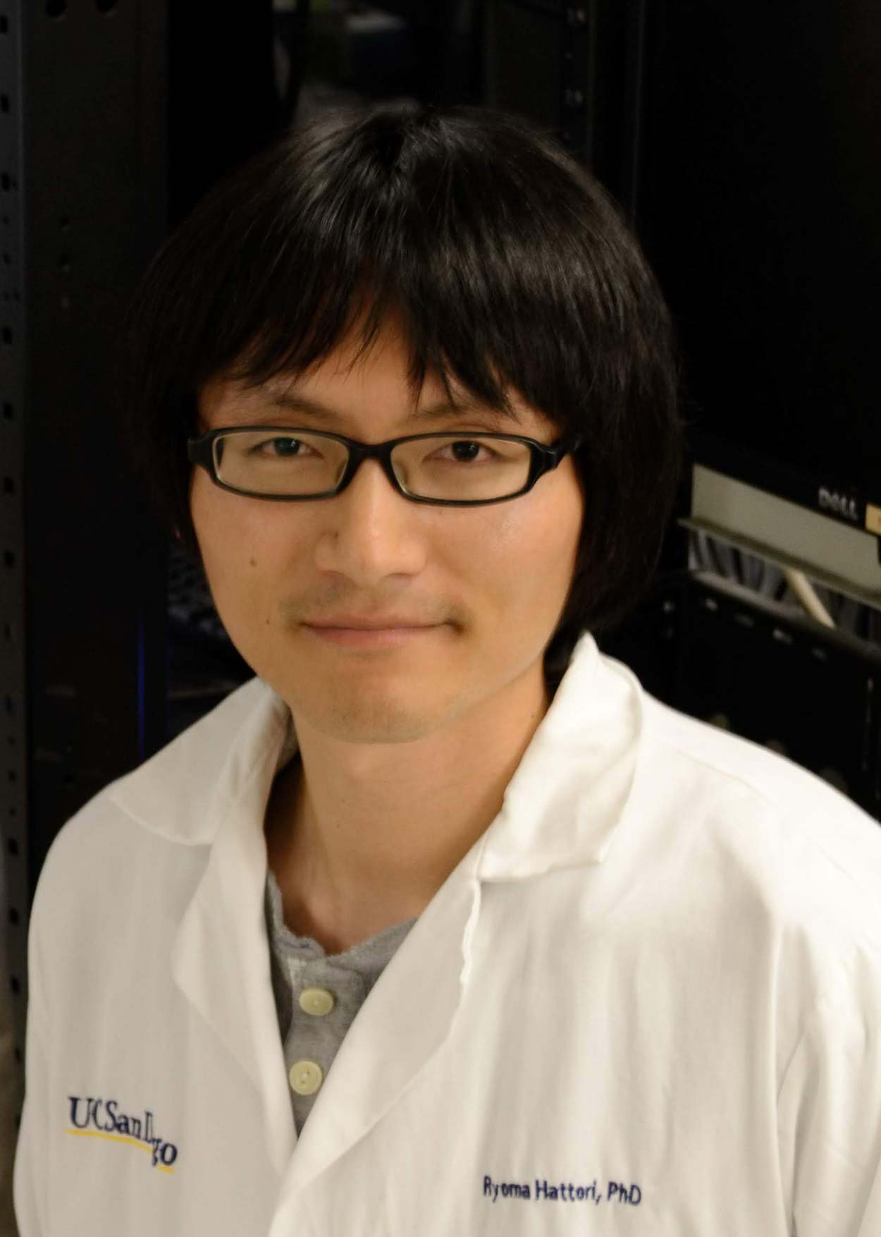 Ryoma Hattori smiling in a lab coat