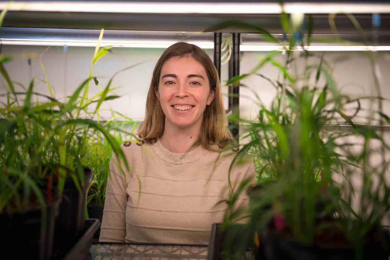 Jazz Dickinson surrounded by plants